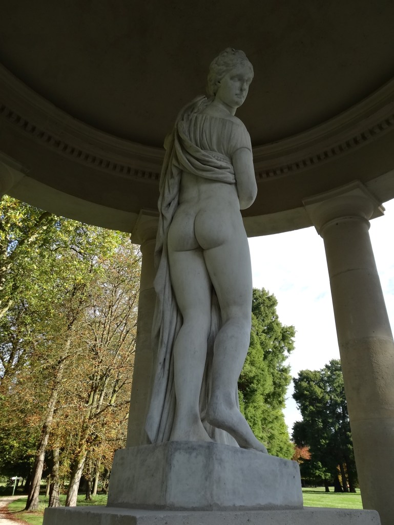 Classic callipygian statue of Venus at Chantilly. Demure on approach but lifts her skirts to reveal her bottom